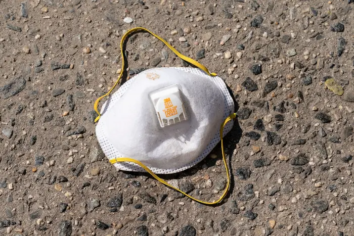 Protective facial N95 mask discarded on sidewalk at Brooklyn Hospital Center Emergency in Brooklyn where patients for COVID-19 have been treated